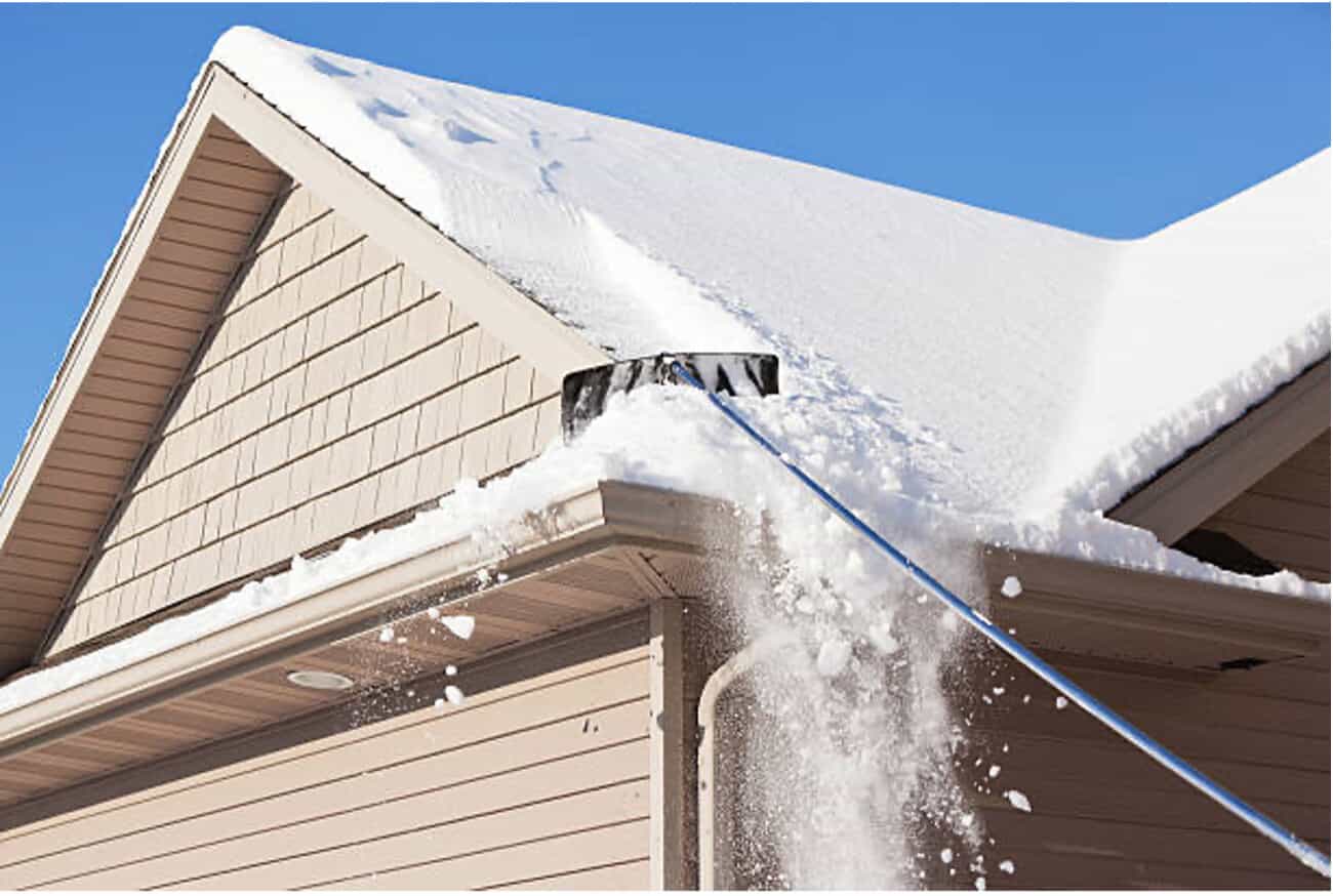 Roof Rake Being Used on Home
